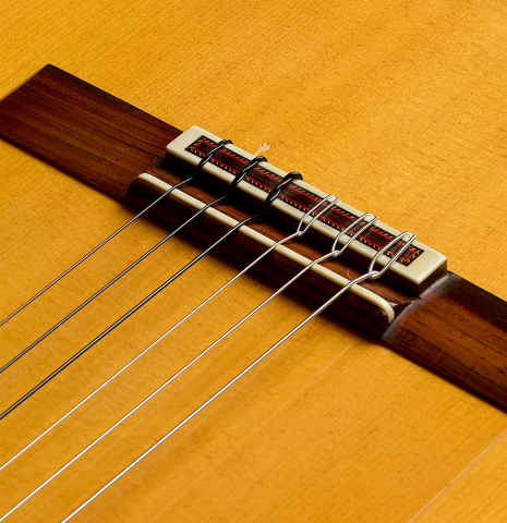 The bridge, tie-block and saddle of a 1983 Manuel Reyes flamenco guitar (ex John Dearman) made of spruce and cypress