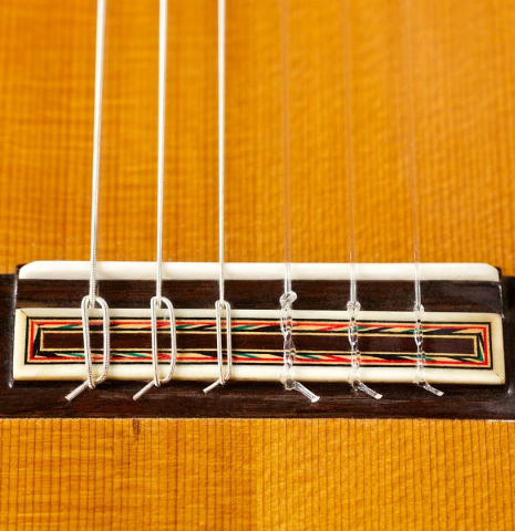 The bridge, tie-block and saddle of a 1968 Miguel Rodriguez (ex Manolo Franco) flamenco blanca guitar made of cedar and cypress