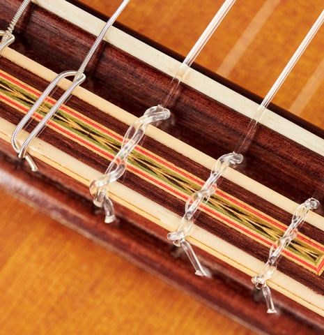 The tie block of a 1971 Miguel Rodriguez flamenco guitar made with cedar and cypress.