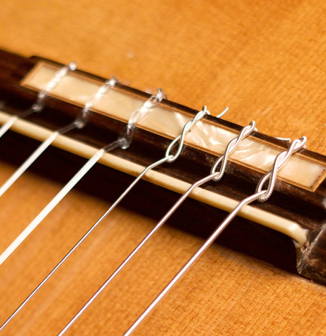 The bridge and saddle of a 1968 Miguel Rodriguez flamenco guitar made of cedar and cypress