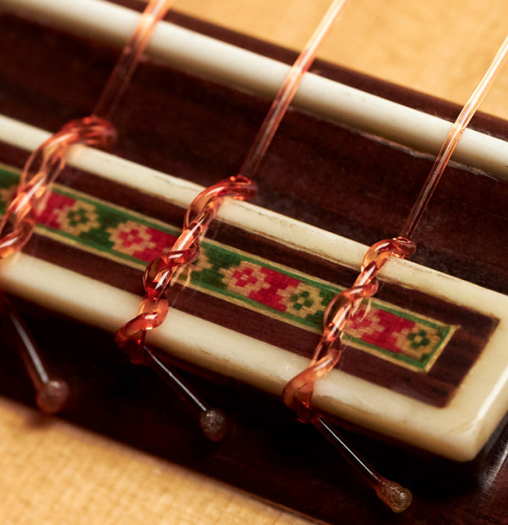 The tie block of a 1990 Miguel Rodriguez flamenco guitar made with spruce top and cypress back and sides.