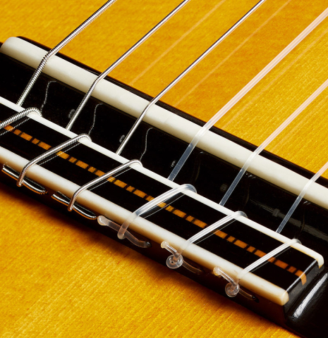 The bridge, tie-block and saddle of a 2024 Rojas &amp; Sanzol flamenco guitar made of spruce and cypress