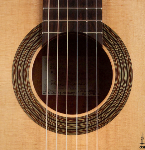 The rosette of a 2020 Pepe Romero &quot;Blanca&quot; flamenco guitar with traditional pegs made of spruce and cypress