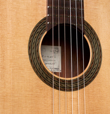 The soundboard and side of a 2020 Pepe Romero &quot;Blanca&quot; flamenco guitar with traditional pegs made of spruce and cypress