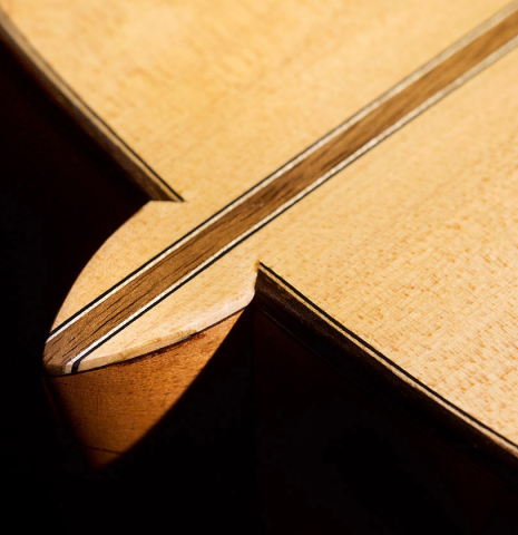 The back and heel of a 2020 Pepe Romero &quot;Blanca&quot; flamenco guitar with traditional pegs made of spruce and cypress