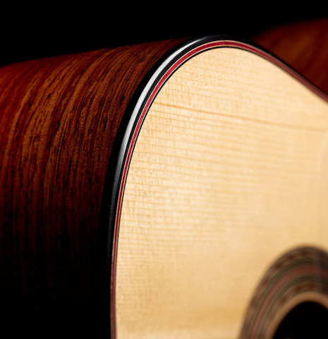 The soundboard and side of a 2024 Pepe Romero "Negra y Blanca" flamenco guitar made of spruce and CSA rosewood