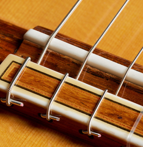 The bridge, tie-block and saddle of a 2009 Tomatito "La Chanca" flamenco guitar made of spruce and cypress