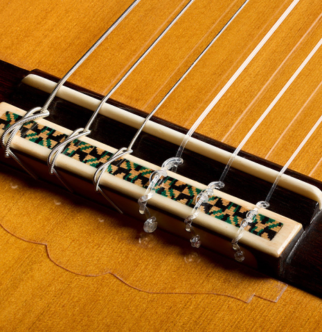 The bridge, tie-block and saddle of a 2026 Emilio Díaz Valero "Blanca" flamenco guitar made of cedar and cypress