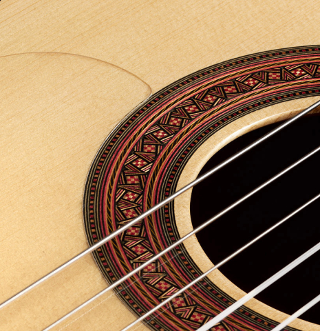 Detailed closeup of the rosette of a 2024 Gao Yi flamenco guitar made of spruce and cypress