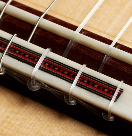 The bridge, tie-block and saddle of a 2024 Gao Yi flamenco guitar made of spruce and cypress