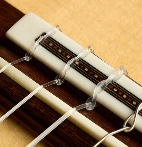 The bridge, tie-block and saddle of a 2026 Gao Yi "Flamenco negra" made of spruce and Indian rosewood