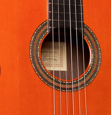 The soundboard and rosette of a 1996 Conde Hermanos &quot;AF 25&quot; flamenco guitar made with spruce and Indian rosewood