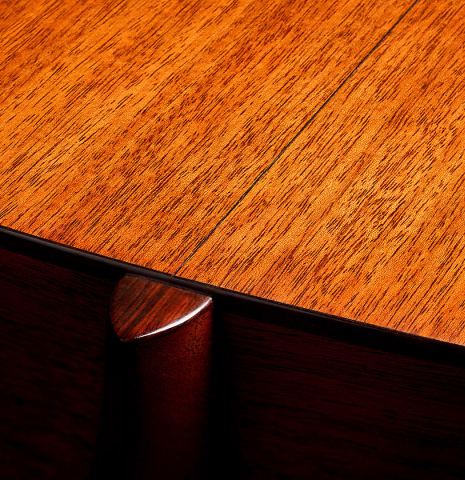 The heel and back binding of a 1951 Martin D-18 steel-string guitar made of spruce and mahogany