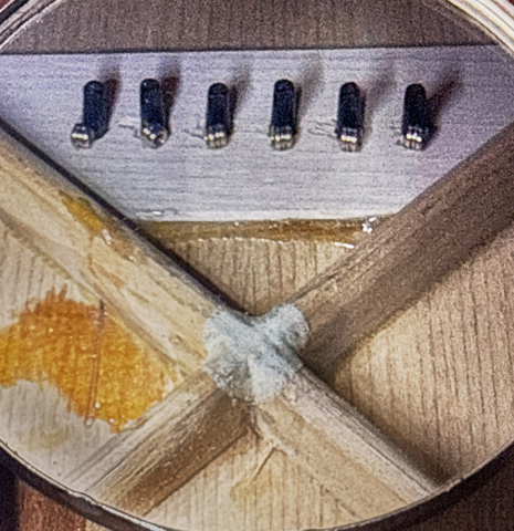 The repair to the top of a 1951 Martin D-18 steel-string guitar made of spruce and mahogany
