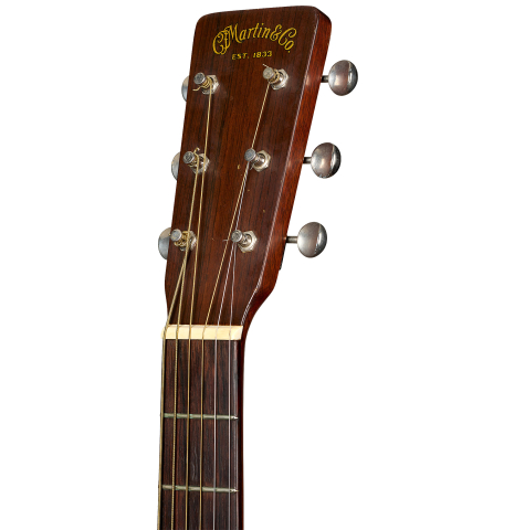 The headstock of a 1951 Martin D-18 steel-string guitar made of spruce and mahogany