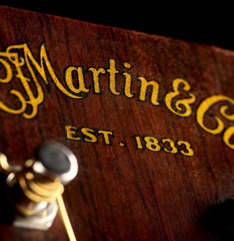 The engraved headstock of a 1951 Martin D-18 steel-string guitar made of spruce and mahogany