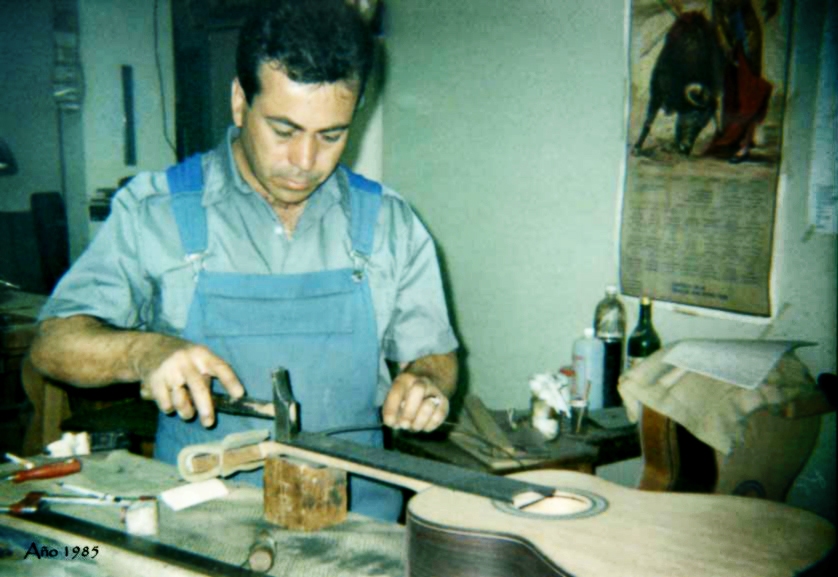 Teodoro Pérez fretting a classical guitar at his workbench in 1985