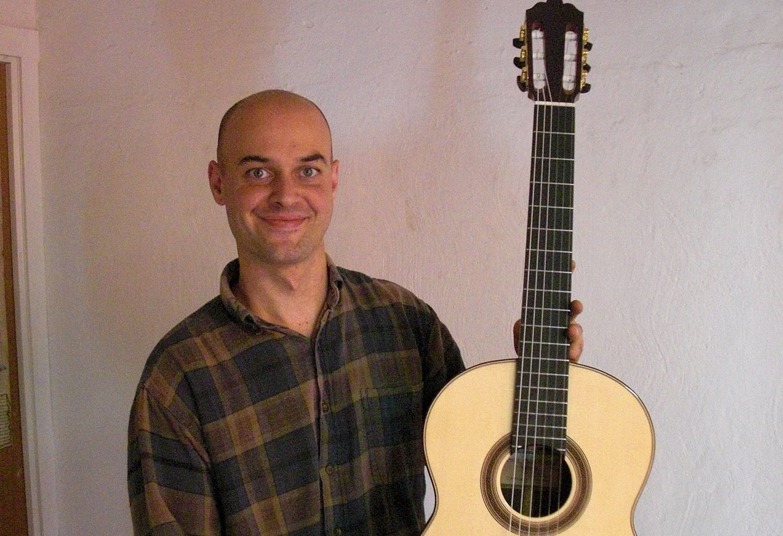 In Granada, guitar maker _____ shows off his latest creation.